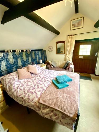 a bedroom with a large bed in a room at Foxhill in Barton