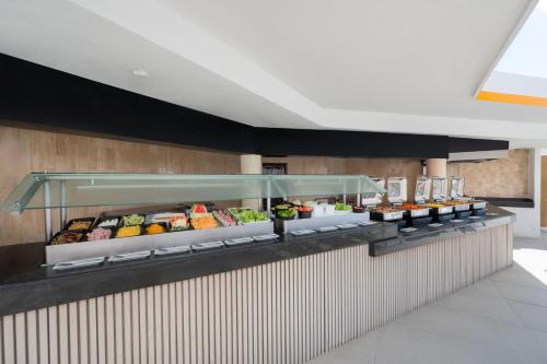 a buffet line in a restaurant with food at GR Solaris Caribe - All Inclusive in Cancún