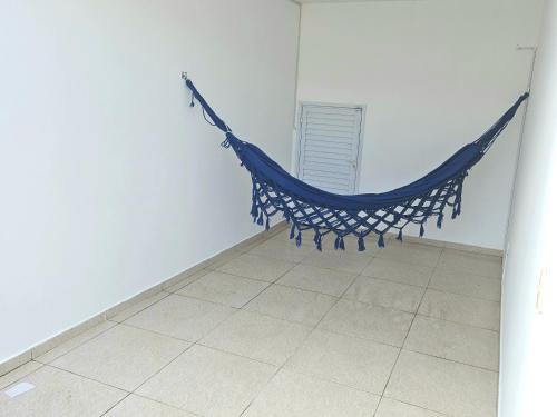 a hammock in a room with a tile floor at Casa de Praia em Jacaraipe soneto do Mar in Serra