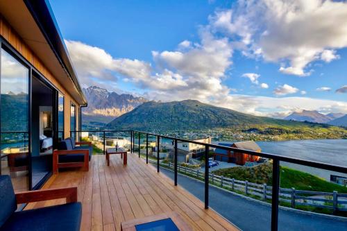 a balcony with a view of the water and mountains at Mountain Lake Vista 3 Bedroom in Queenstown