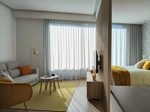 a hotel room with a bed and a living room at Apartamento Mimosa Diseño Exclusivo in Ponteareas