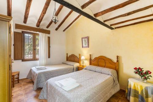 Postel nebo postele na pokoji v ubytování Cortijo La Mata - Casas Rurales Luis