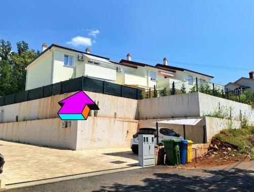 a house with a colorful umbrella sign in front of it at Apartment Tanya in Rijeka