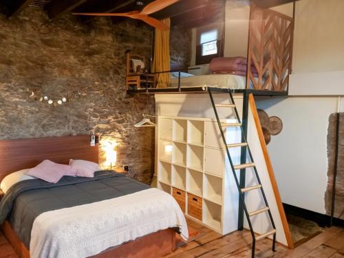 a bedroom with a bunk bed and a bunk ladder at El Petit Paradís in Bellestar