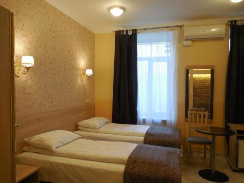 Ένα ή περισσότερα κρεβάτια σε δωμάτιο στο Gogol Park Rooms