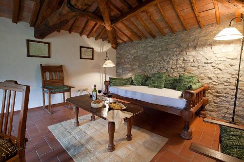 a bedroom with a bed in a stone wall at Castello Di Gabbiano in Mercatale Val Di Pesa