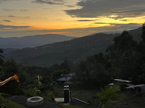 a view of a mountain with a sunset in the background at Monor Loft in Miravalles