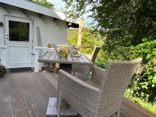 a table and chairs on a wooden deck with a door at foresthaus in Glücksburg