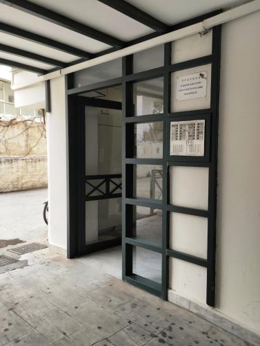an open door on a building with a window at Rethymno Central Studio in Áyios Andónios