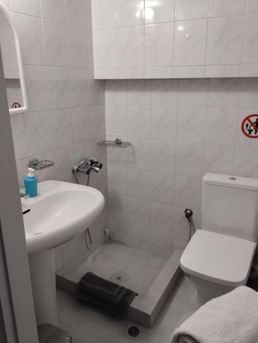 a small bathroom with a sink and a toilet at Rethymno Central Studio in Áyios Andónios