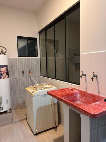 a bathroom with a red counter and a sink at Casa Jardín Tarija in Tarija