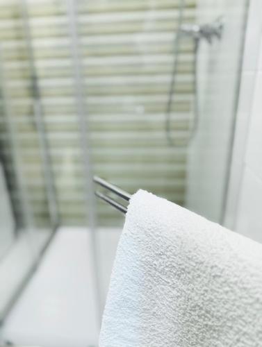 a roll of white towels sitting on a table at Léda Apartmanok 1-2 Siófok Aranypart in Siófok