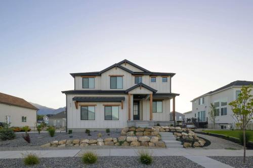a white house with a black roof at Lakeside Provo Getaway in Provo