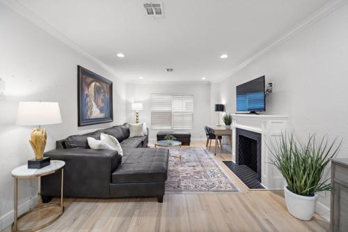 a living room with a couch and a fireplace at The Bishops Haven 4 in Houston