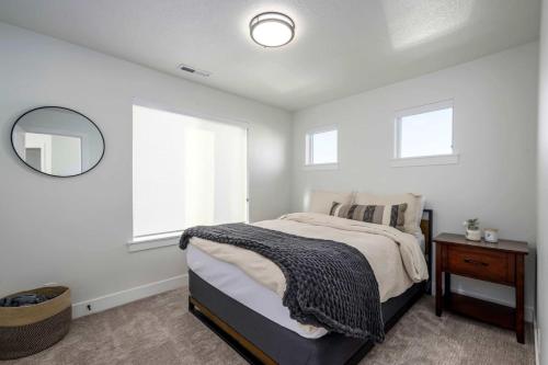 a bedroom with a large bed and a mirror at Lakeside Provo Getaway in Provo