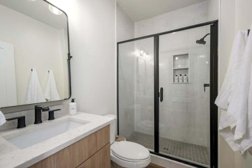 a bathroom with a shower and a toilet and a sink at Lakeside Provo Getaway in Provo