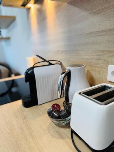 a toaster sitting on top of a wooden table at Léda Apartmanok 1-2 Siófok Aranypart in Siófok