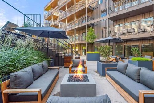 a patio with couches and a fire pit in front of a building at Penthouse Luxury with Pool Patio and City View plus Walk to Broadway in Nashville