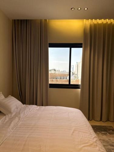a bedroom with a large bed and a window at شقه فاخره وسط حي السليمانيه in Riyadh