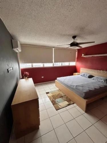 a bedroom with a bed and a ceiling fan at Private King Room with bath in Shared Apartment in San Juan