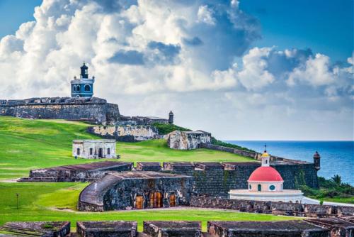 a view of the ruins of a castle with a lighthouse at Private King Room with bath in Shared Apartment in San Juan