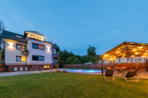 a house with a yard with a patio and a pool at Willowa 21 in Wisła