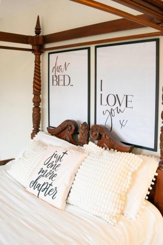a bedroom with a bed with two framed windows at 3-Bed gem with Bath Abbey views in Bath