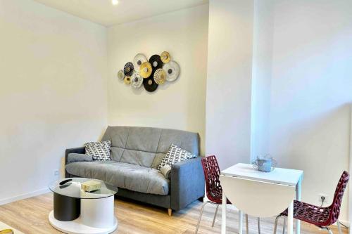 un salon avec un canapé et une table dans l'établissement neuf climatisé et proche métro, à Villeurbanne
