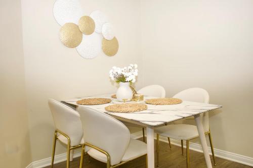 a white dining room with a table and chairs at Marina Del Rey Apartment Luxury pool, gym, parking, BBQ in Los Angeles