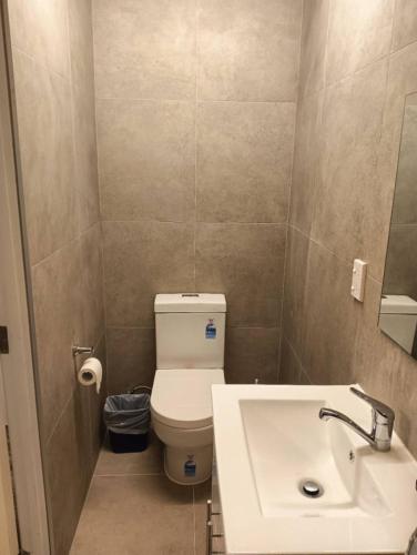 a bathroom with a white toilet and a sink at 2 Beds including 1 Sofa Bed Serviced Chalet B in Rotorua