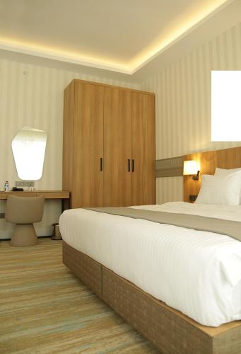 a bedroom with a large white bed and wooden cabinets at Tress Hotel in Istanbul