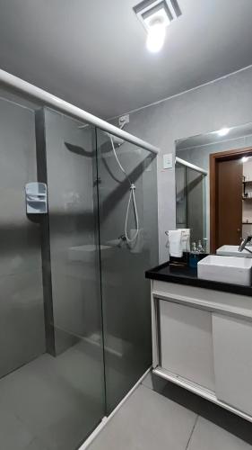 a bathroom with a shower and a sink at Flat Studio in João Pessoa
