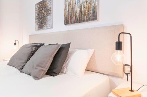 a white bed with pillows on top of it at Refugio de Montaña, Terraza con Vistas y Parking I AndBnB in Arinsal