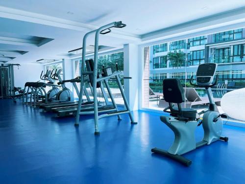 a gym with several treadmills and exercise bikes at Royal Lee Phuket Condominium Airport in Ban Bo Han