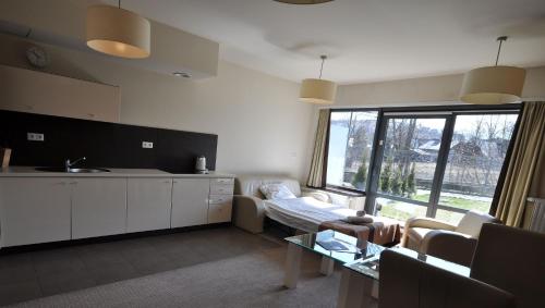 a kitchen and living room with a couch and a table at Szklane Domy in Zakopane
