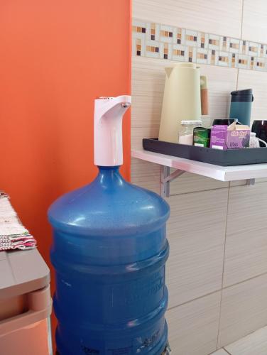 a large blue water bottle with a white top at Pousada Angatu, microcasa em BH in Belo Horizonte