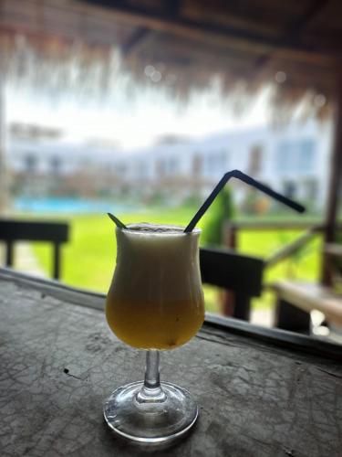 a drink in a glass sitting on a table at Hotel Kendari - Chincha in Chincha