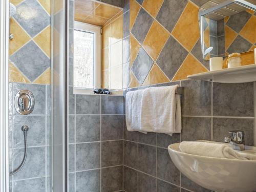 a bathroom with a sink and a shower at Bergzeit Fieberbrunn 1 in Hütte