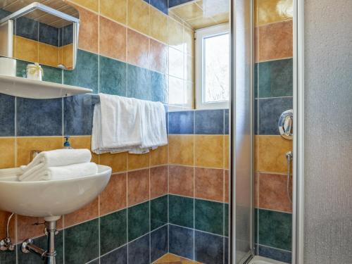 a bathroom with a sink and a shower at Bergzeit Fieberbrunn 1 in Hütte