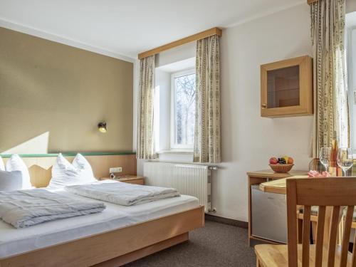 a hotel room with a bed and a desk at Bergzeit Fieberbrunn 2 in Hütte