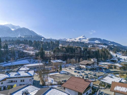 an aerial view of a town with snow covered mountains at Bergzeit Fieberbrunn 2 in Hütte