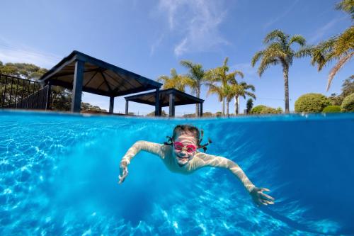 a young girl in a swimming pool at BIG4 Wallaga Lake Holiday Park in Bermagui