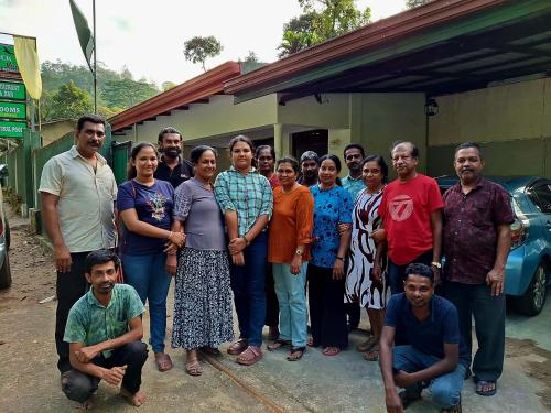 a group of people standing in front of a house at Rock View Holiday Bungalow in Matale