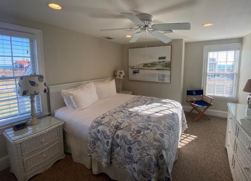 a bedroom with a bed and a ceiling fan at Beach Breeze Inn in Falmouth