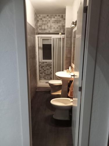 a bathroom with two toilets and a sink at Piso Barbate in Barbate