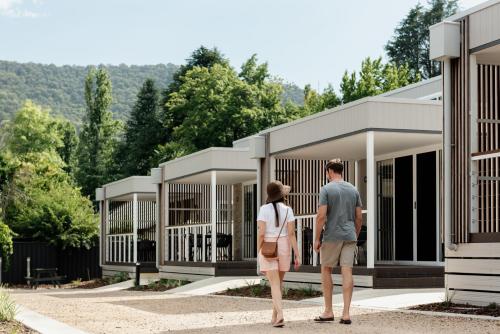 a man and a woman standing in front of some cages at Tasman Holiday Parks - South Bright in Bright