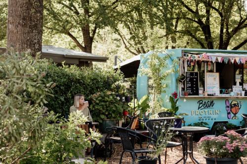 a food truck parked in a garden with tables and chairs at Tasman Holiday Parks - South Bright in Bright
