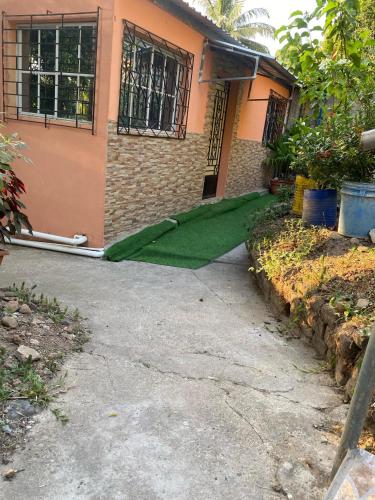 a green carpet on the front of a house at Aguiñada's House in El Rosario