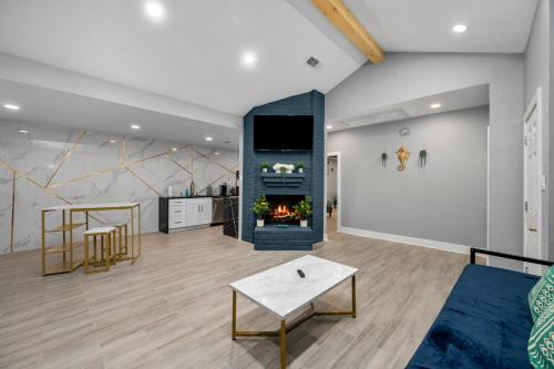 a living room with a fireplace and a table at Modern & Spacious 1BR Haven near Galleria in Houston