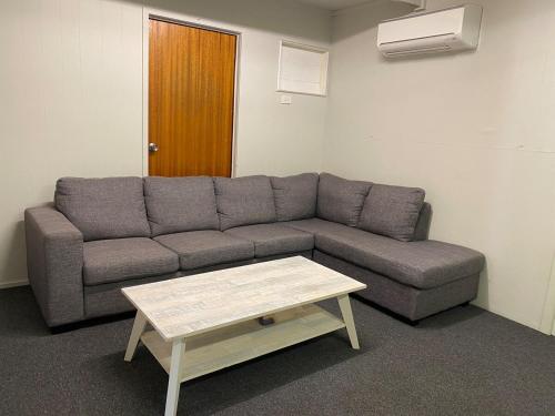 a living room with a couch and a coffee table at Akubra Downs, Yeppoon -Cottage 3 bedroom in Cawarral